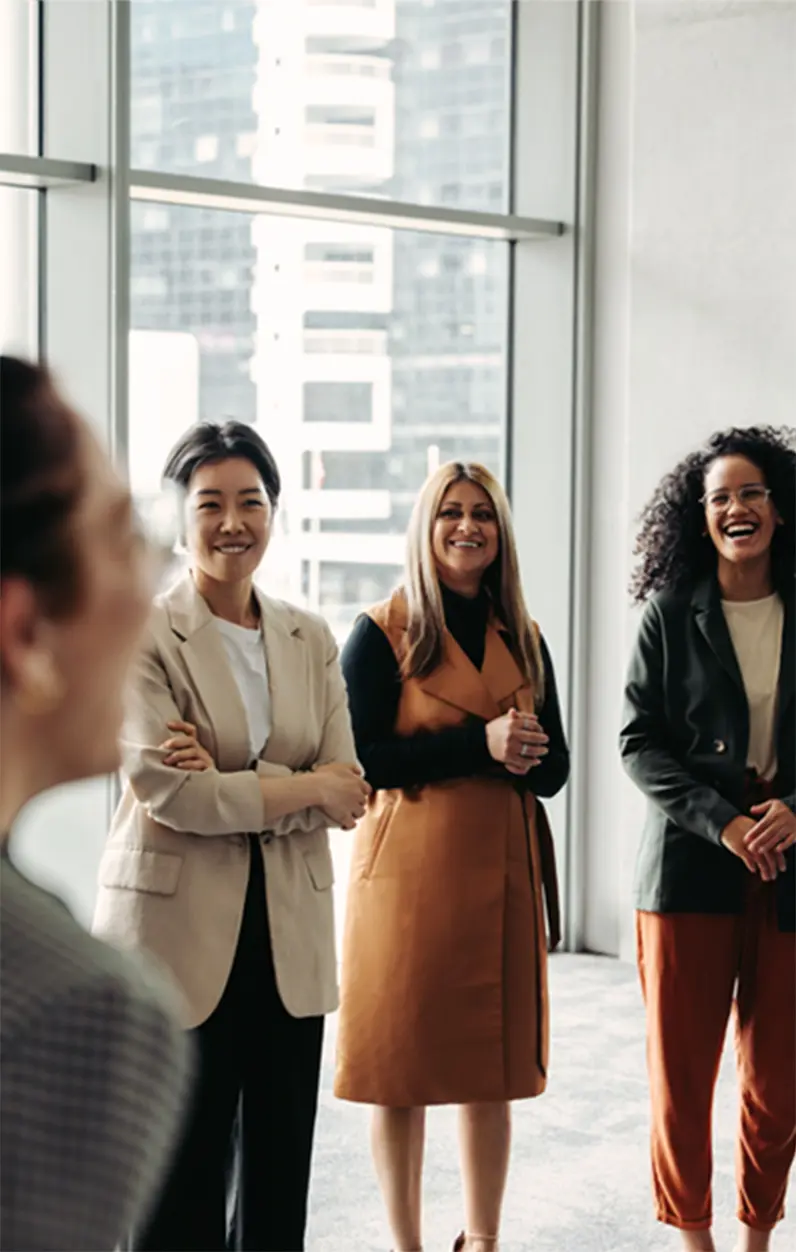 Professionals laughing together during a fun group activity, highlighting how The Thread Experience reveals unexpected common threads between strangers.